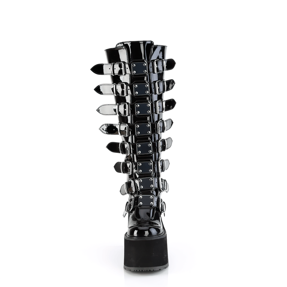 Demonia black platform knee-high boots featuring metal buckle straps and a sleek back zip closure.
