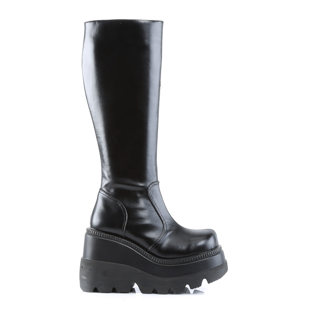 Daring DEMONIA black knee-high stacked wedge platform boots with side zipper, perfect for edgy outfits.