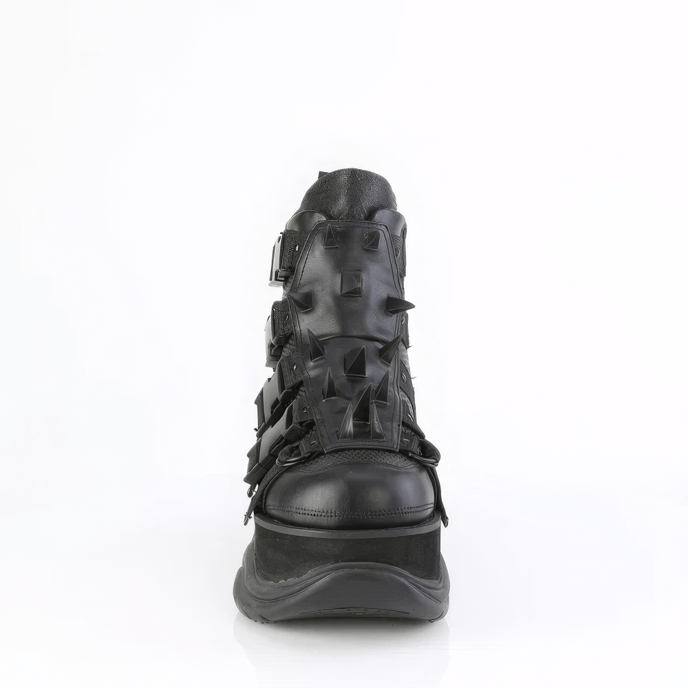 Demonia Black Studded Shield Platform Ankle Boot with claw spikes and buckle detailing, showcasing bold edgy style.