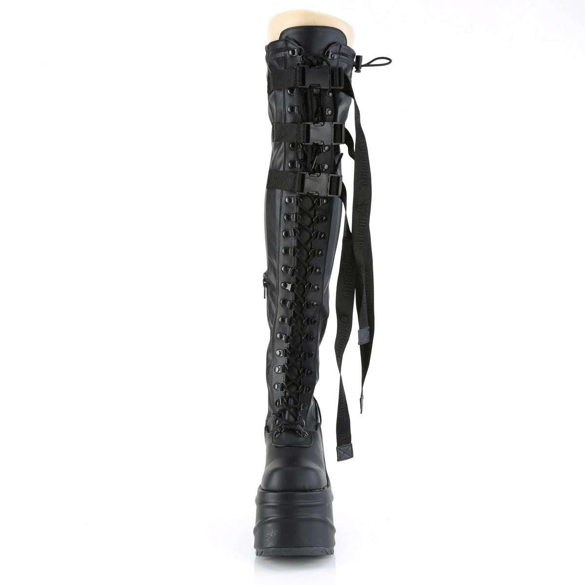 Demonia black thigh-high wedge boots featuring lace-up design, snap buckles, and branded nylon straps for a striking look.