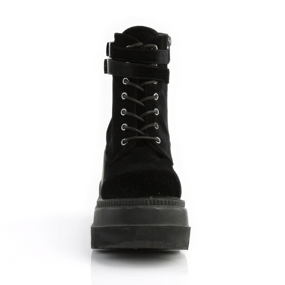 Demonia black velvet platform boots with lace-up front and double-buckled strap for an edgy look.