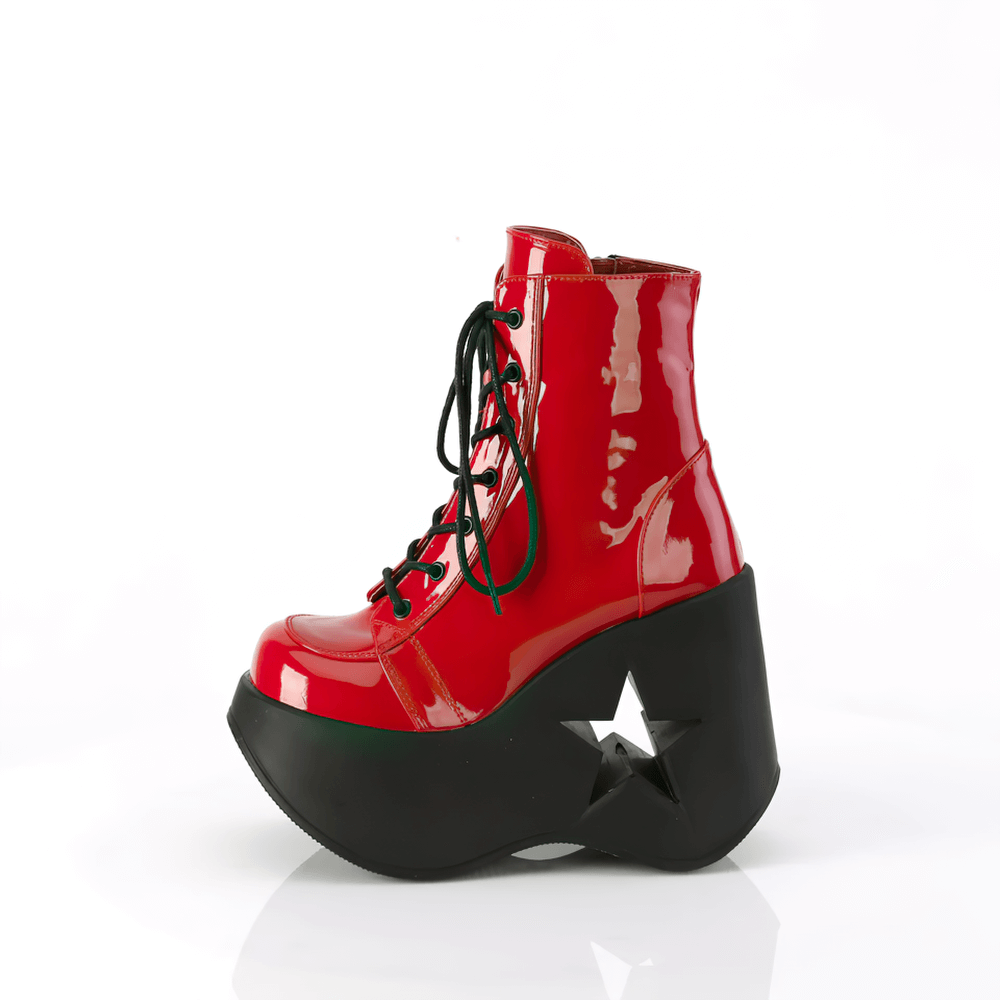 Daring glossy red lace-up ankle boot with 5" star platform wedge and black sole, a bold fashion statement.
