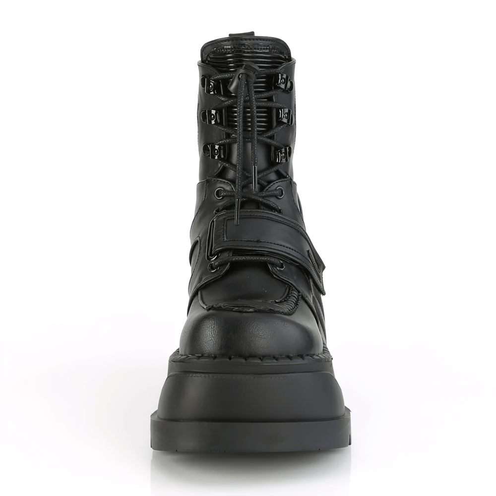 Demonia bold wedge ankle boots in black vegan leather with lace-up front and straps, showcasing an edgy design.
