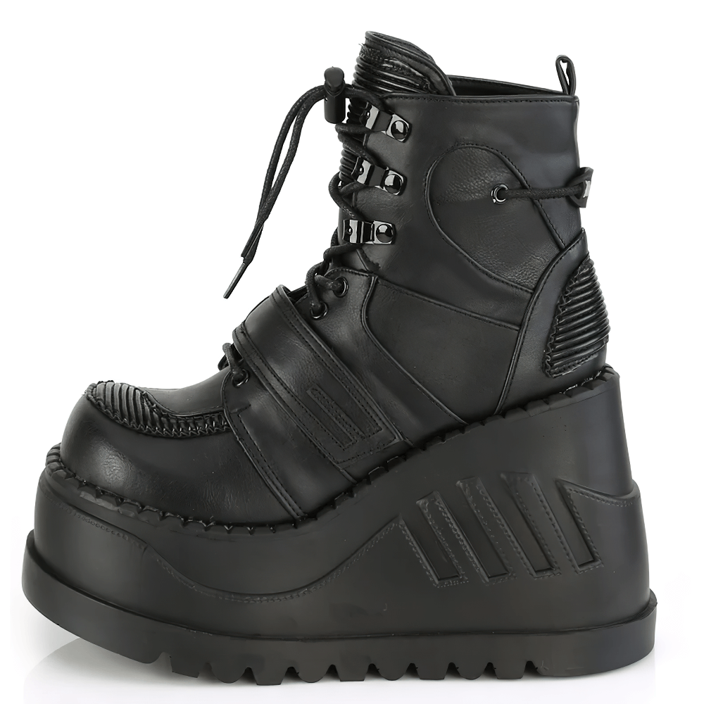 Demonia bold wedge ankle boots in black vegan leather with lace-up and straps, showcasing an edgy platform style.