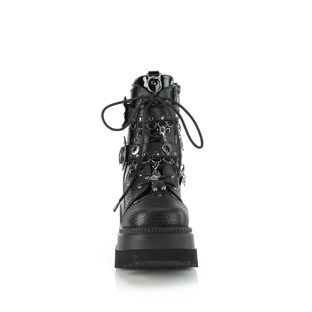 Demonia women's edgy platform ankle boots with bat buckle details and charms, featuring a 4.5-inch wedge.