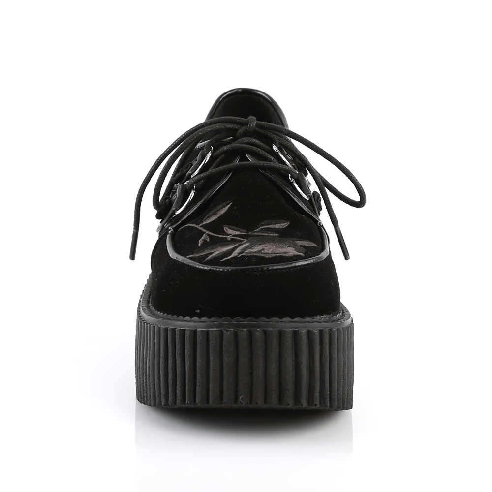 Front view of DEMONIA black velvet lace-up creepers with floral embroidery and 3-inch platform.