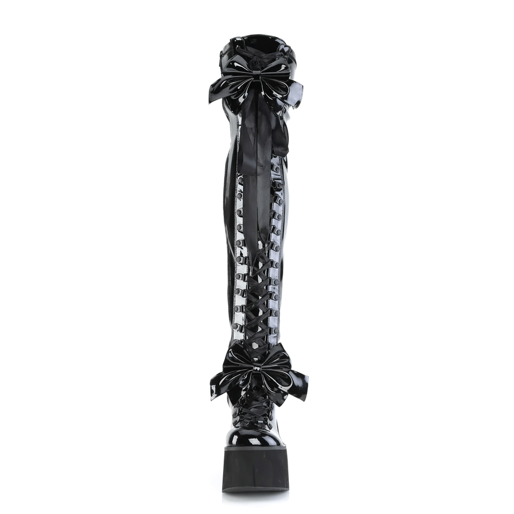 Daring glossy black thigh-high lace-up platform boots with oversized bows and adjustable straps for customizable style.