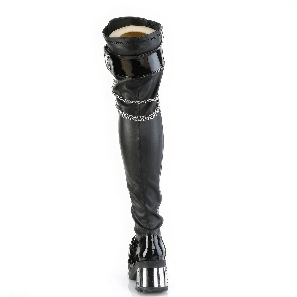 Demonia over-the-knee boots featuring chunky heel, chains, and eyelet details for a rebellious punk style.