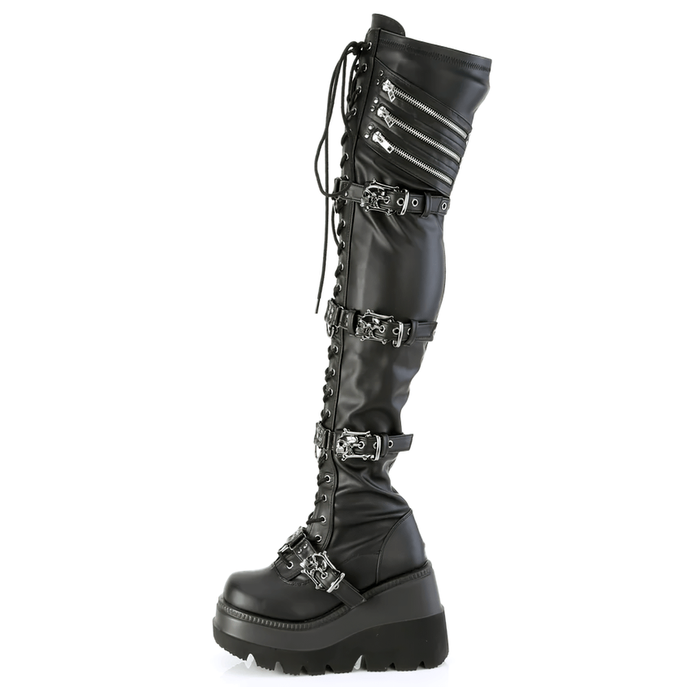 Demonia gothic thigh high boots with skull buckles and lace-up detailing, featuring a 4.5-inch wedge platform.