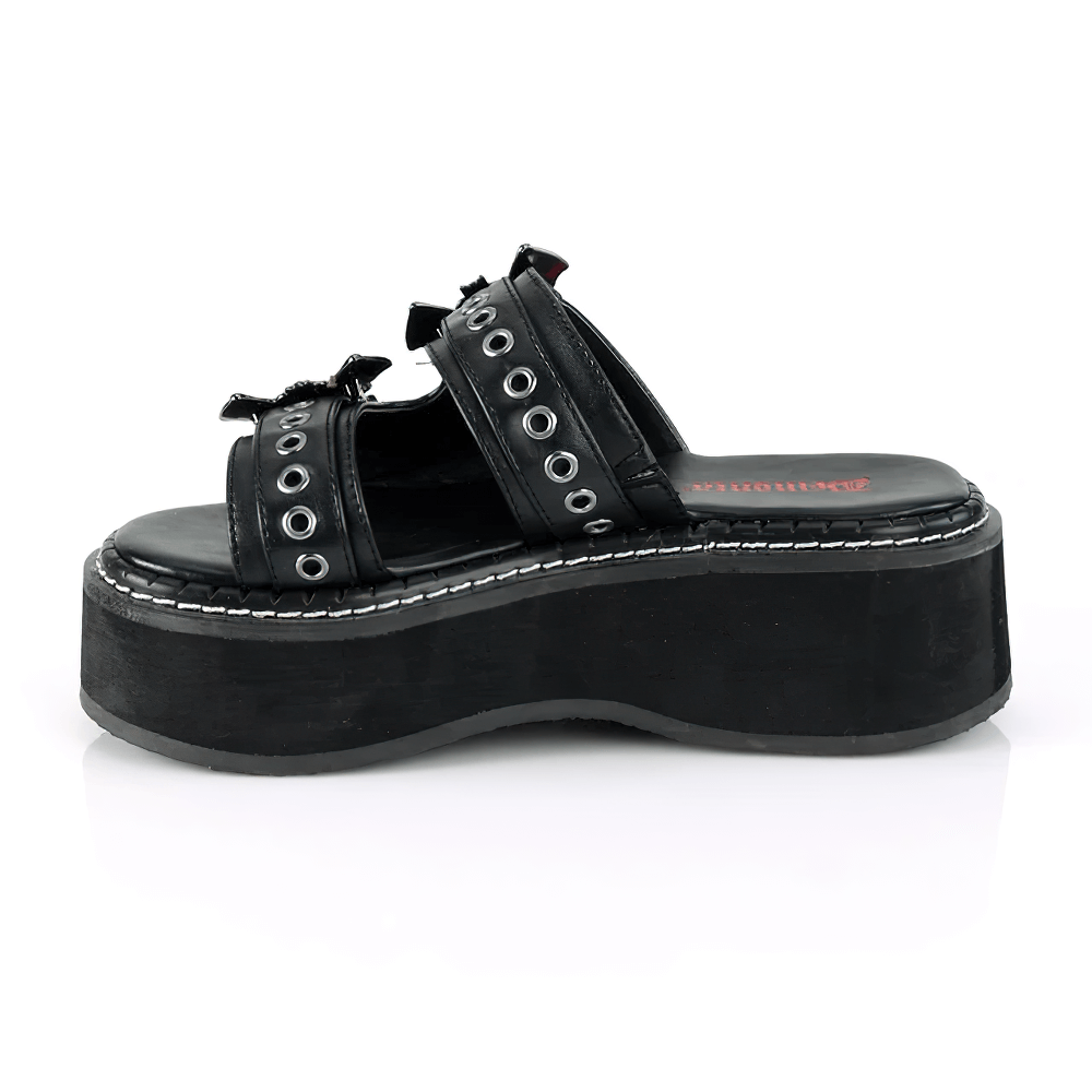 Demonia gothic slide sandals in black vegan leather with riveted double straps and bat buckles, featuring a bold 2" platform.