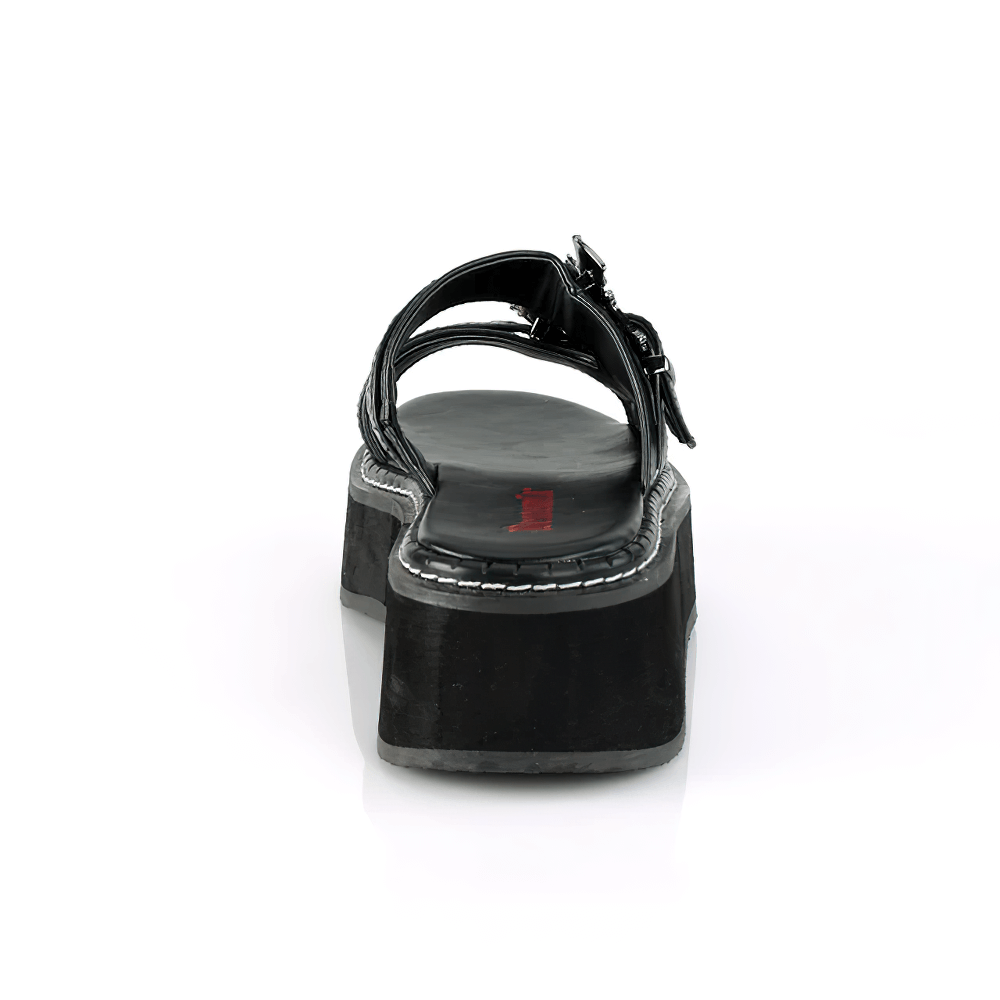 Back view of DEMONIA gothic slide sandals with riveted double straps and bat buckles, showcasing black vegan leather and thick platform.