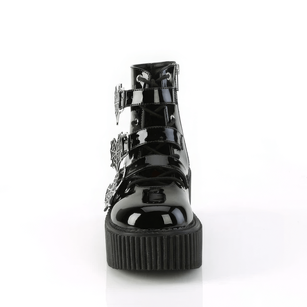 Front view of DEMONIA Gothic Spider Web Strap Platform Boots in shiny black patent vegan leather.