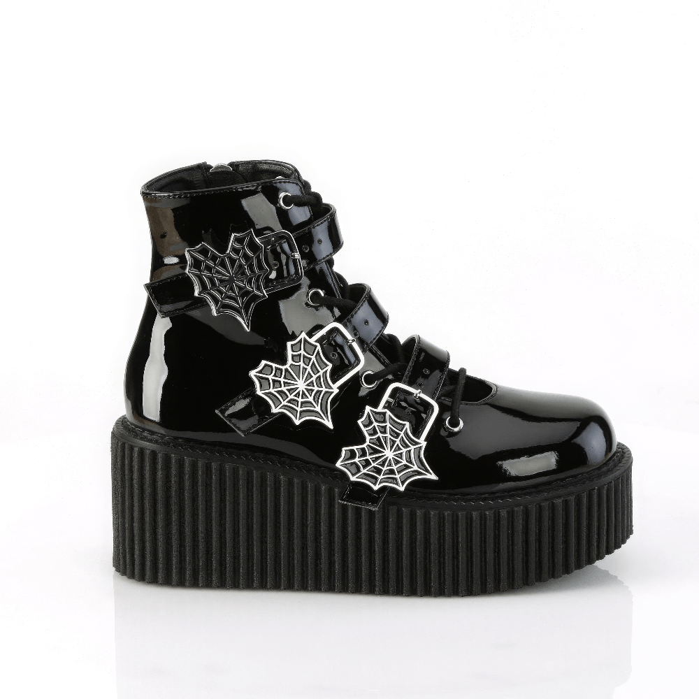Gothic spider web strap platform boots in sleek black patent vegan leather with heart-shaped buckles.