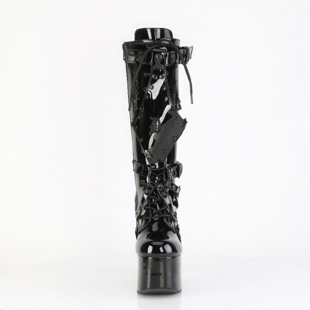 Demonia knee-high platform boots with barbed wire chain and skull studs, featuring a lace-up front and vegan patent leather.