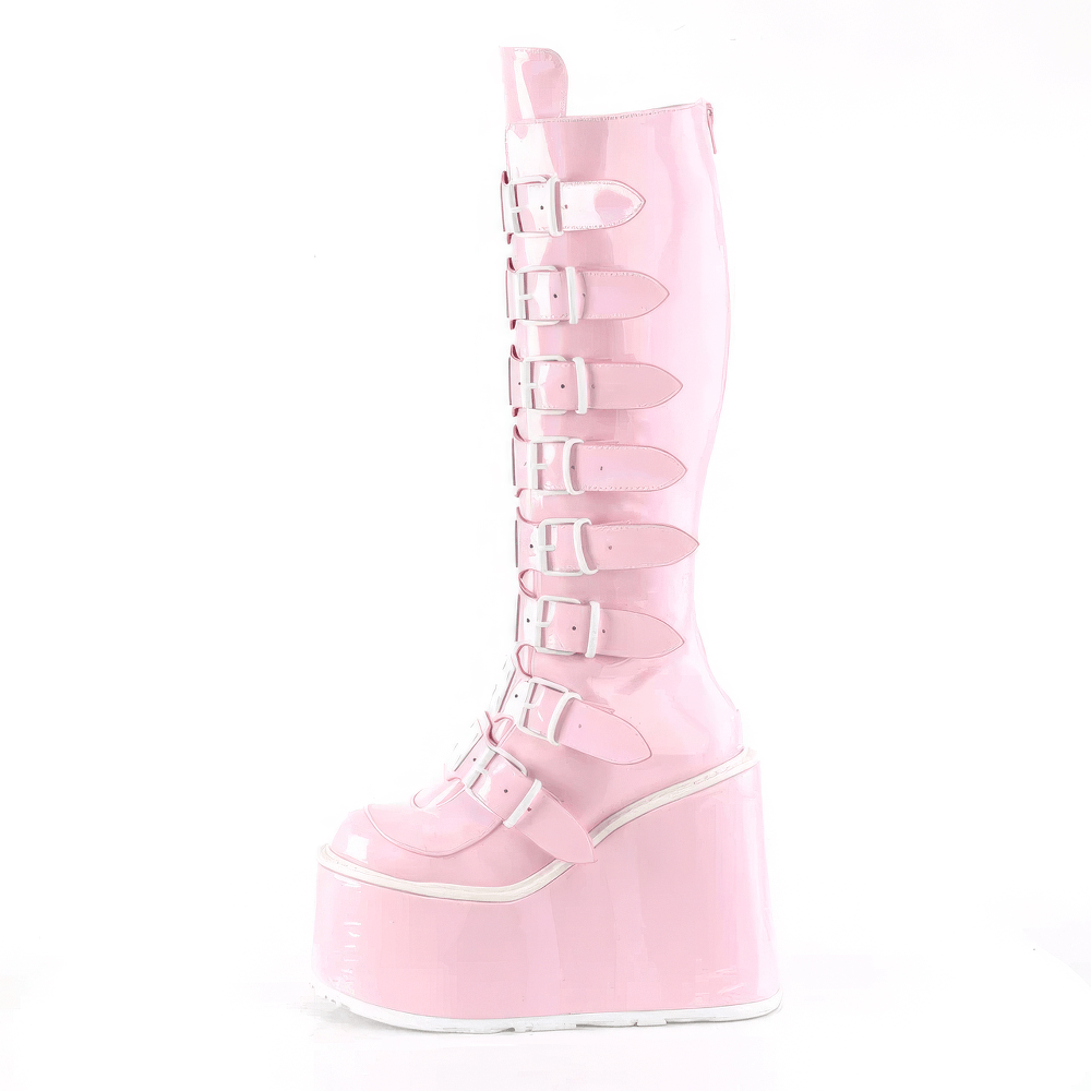 Iridescent pink knee-high platform boots with buckle straps and metal accents, showcasing edgy style and holographic shine.