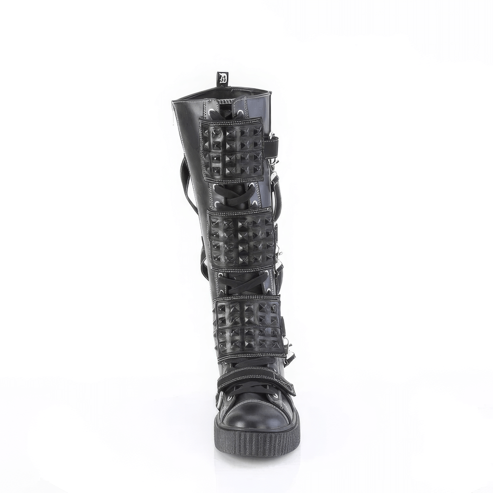 Edgy knee-high platform boots with studded straps and lace-up front, perfect for a bold fashion statement.