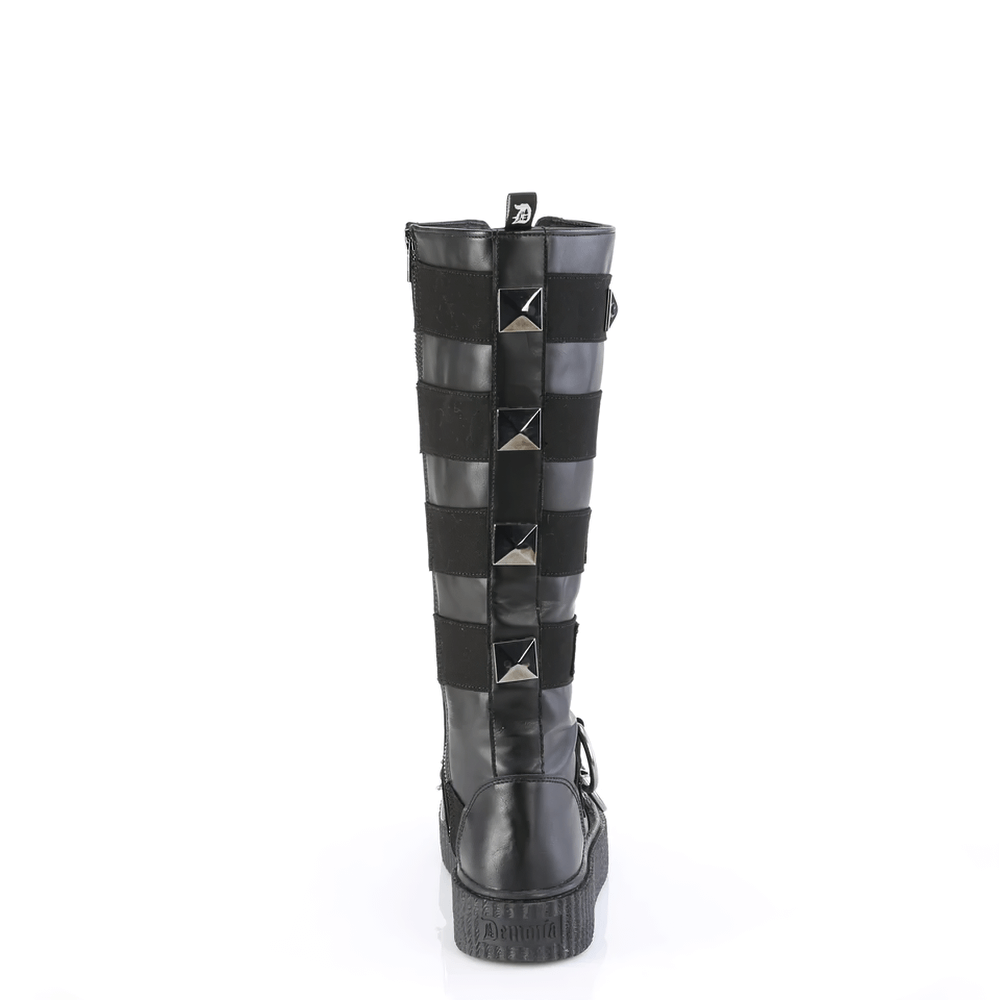 Back view of DEMONIA Lace-Up Knee-High Creeper Boot with pyramid studs and striped panels.