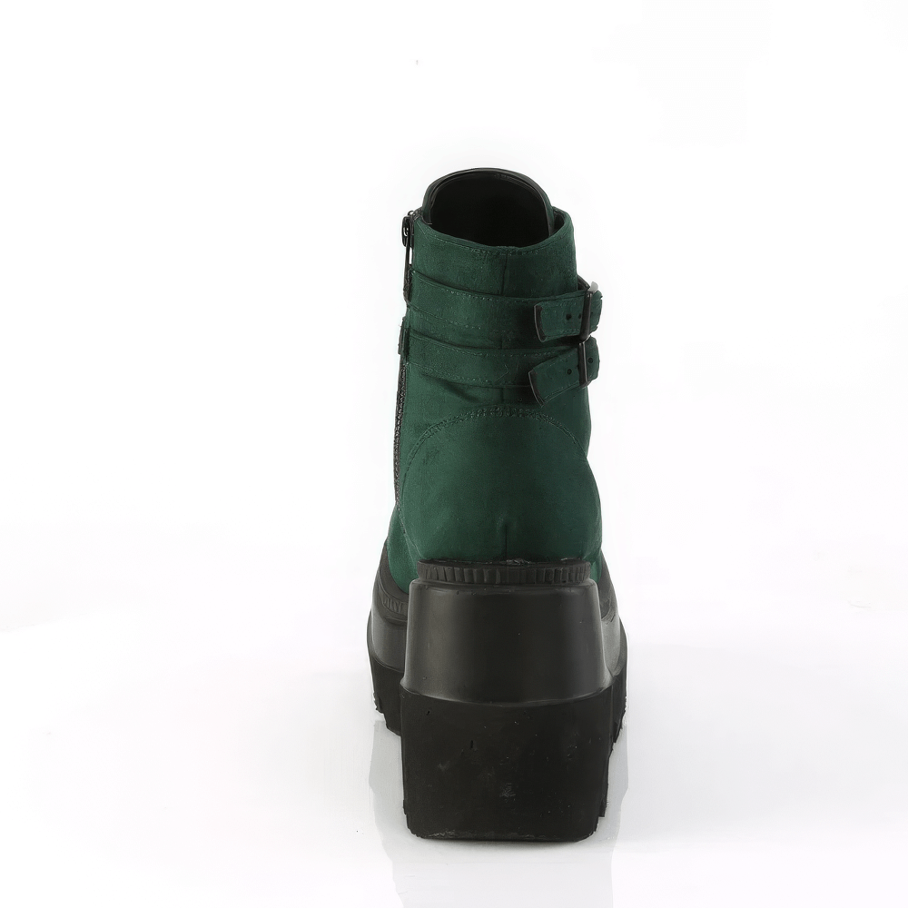 Back view of DEMONIA lace-up platform ankle boots with dual buckles in green vegan suede.