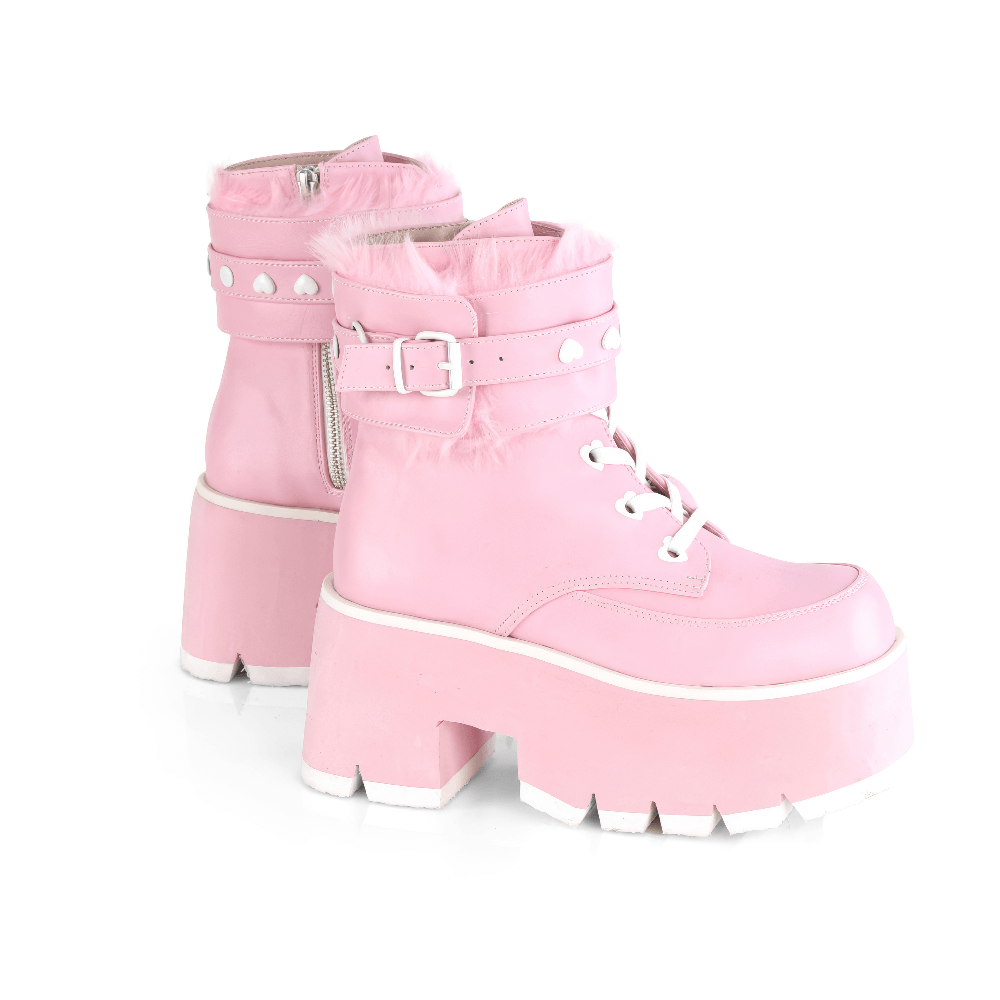 Dare to shine in DEMONIA pink fur-cuffed platform boots with heart details and chunky heels for a stylish, bold look.
