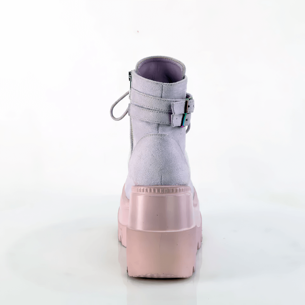 Demonia lavender wedge platform ankle boots with buckled straps, showcasing a pastel purple design and sleek back view.