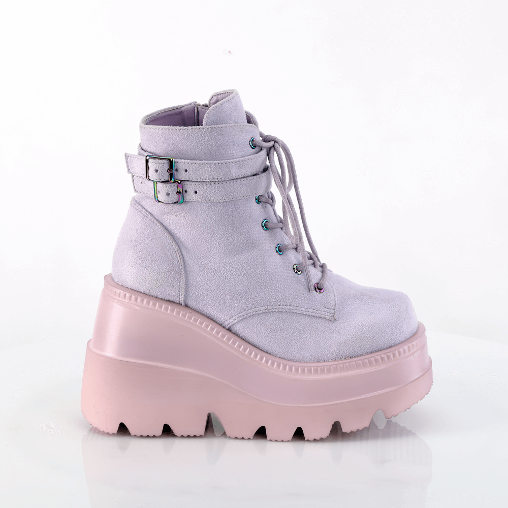 Demonia lavender wedge platform ankle boots with buckle straps, featuring lace-up design and a stylish pastel purple finish.
