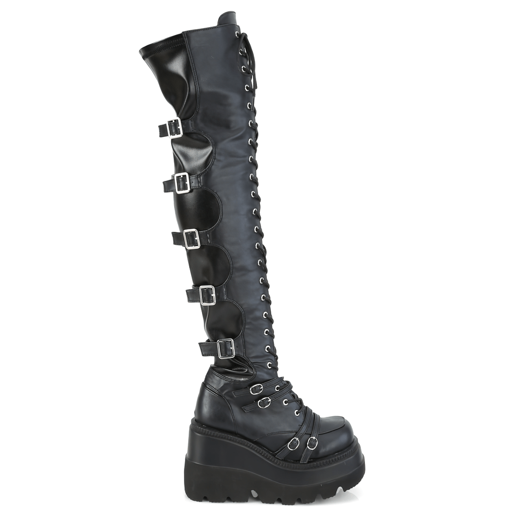 Over-the-knee lace-up vegan leather boots with buckles and a platform sole, showcasing a stylish design.