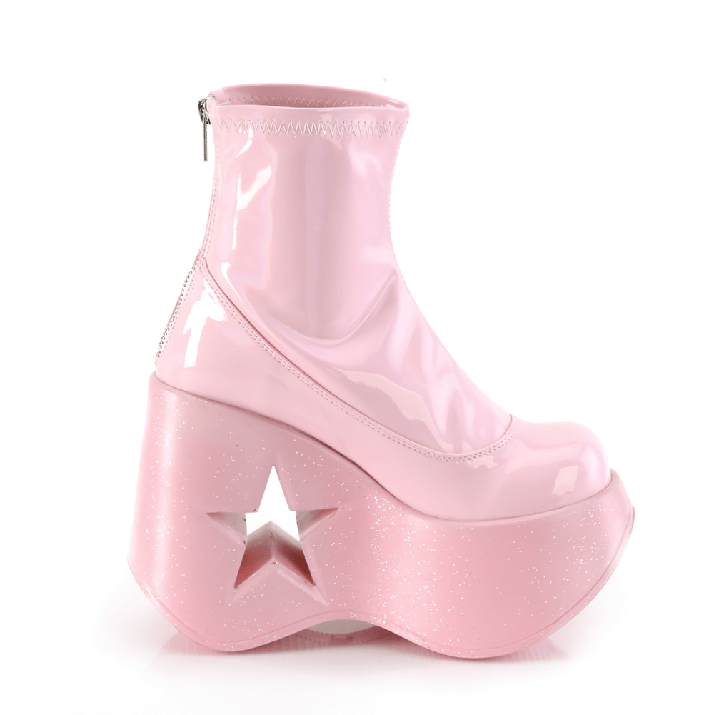 Demonia pink holographic star cutout platform ankle boots side view with shiny finish and 5-inch wedge.
