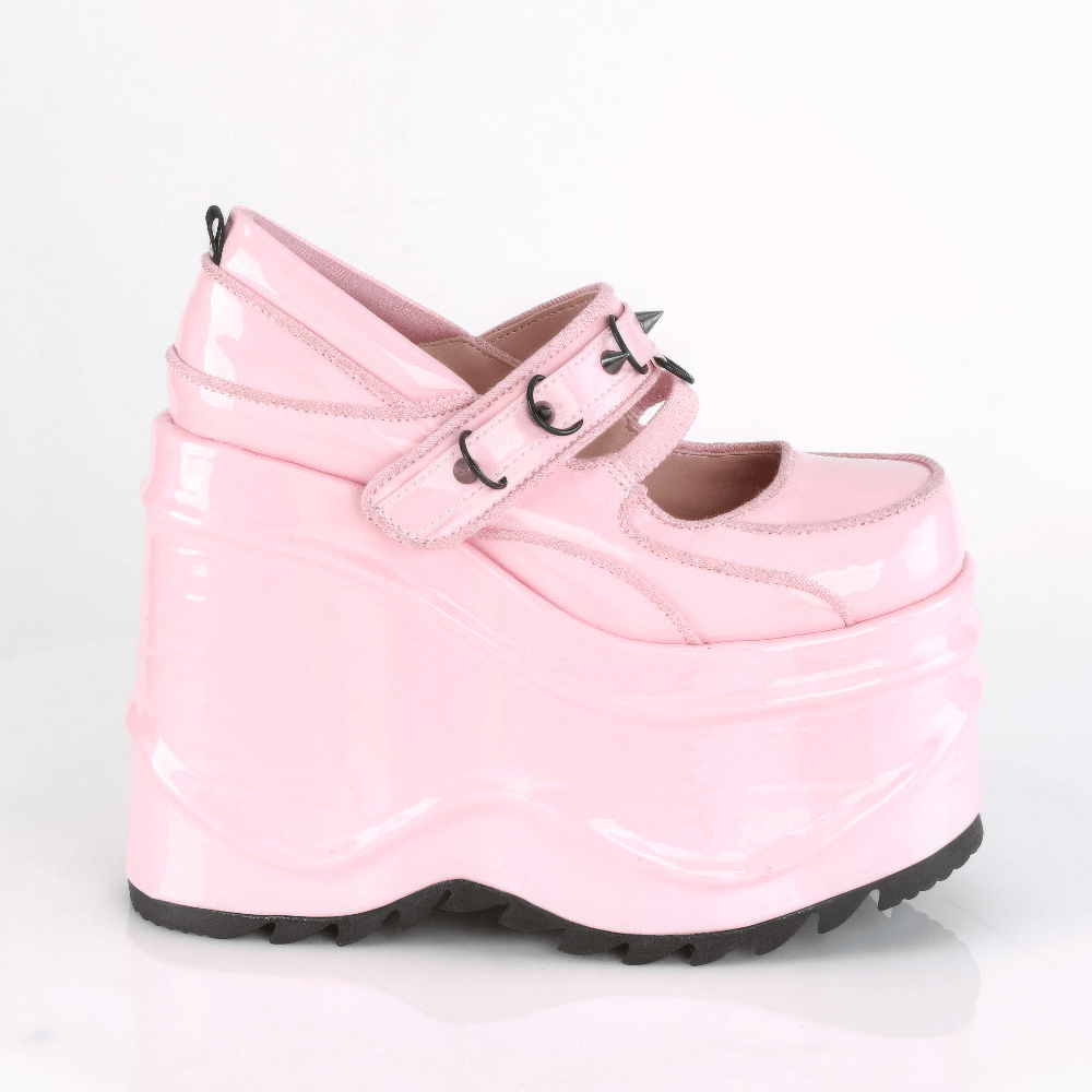 Playful pink platform Mary Jane shoes with cone spike details and straps on a bold design.