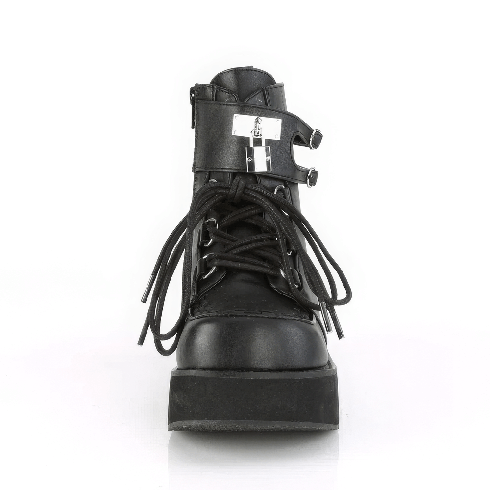 Dare to stand out in DEMONIA lace-up ankle boots with platform, metal lock charm, and interwoven strap detailing.