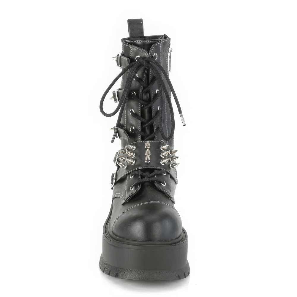 Bold Demonia mid-calf platform boot with spike buckle straps, featuring a flexible lace-up design and durable black vegan leather.
