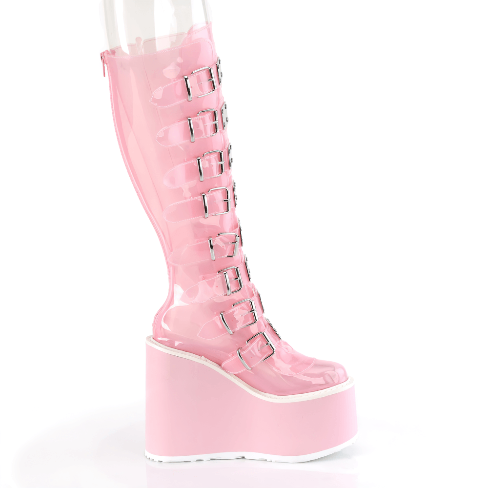 Bold baby pink knee-high platform boots with buckle straps, showcasing a sleek translucent design.