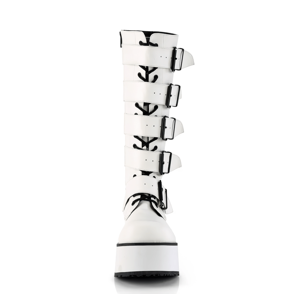 Daring white vegan leather knee-high platform boots with dynamic buckle straps and lace-up design.