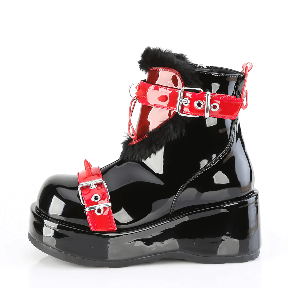 Black patent leather ankle boots with red buckle straps and fur accents, featuring a bold platform design.