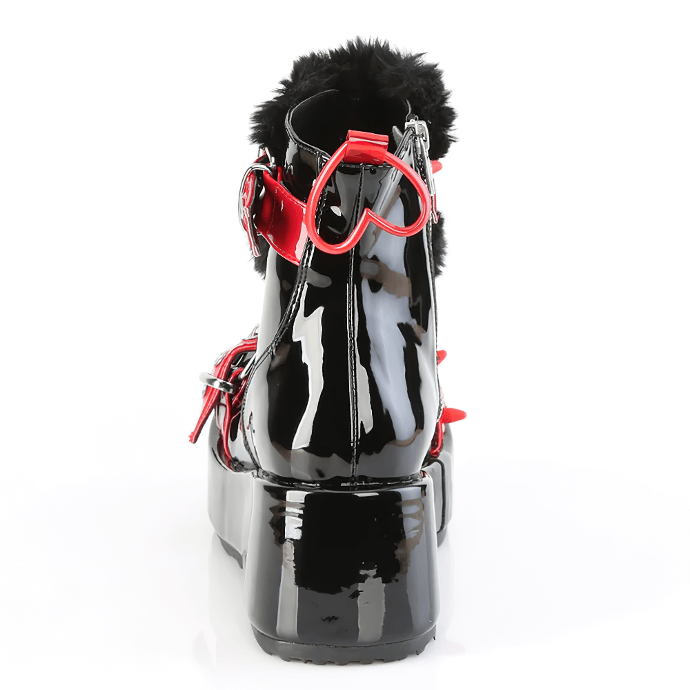 Rear view of DEMONIA ankle boots featuring black shine, fur accents, and bold heart detail.