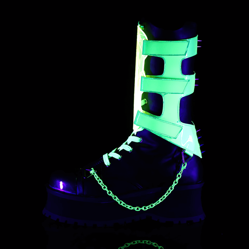 Futuristic black mid-calf platform boots with UV-reactive straps and chain details under blacklight.
