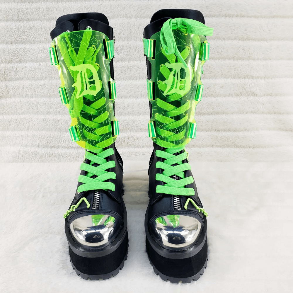 Futuristic punk UV reactive mid-calf platform boots with silver toe cap and green accents.
