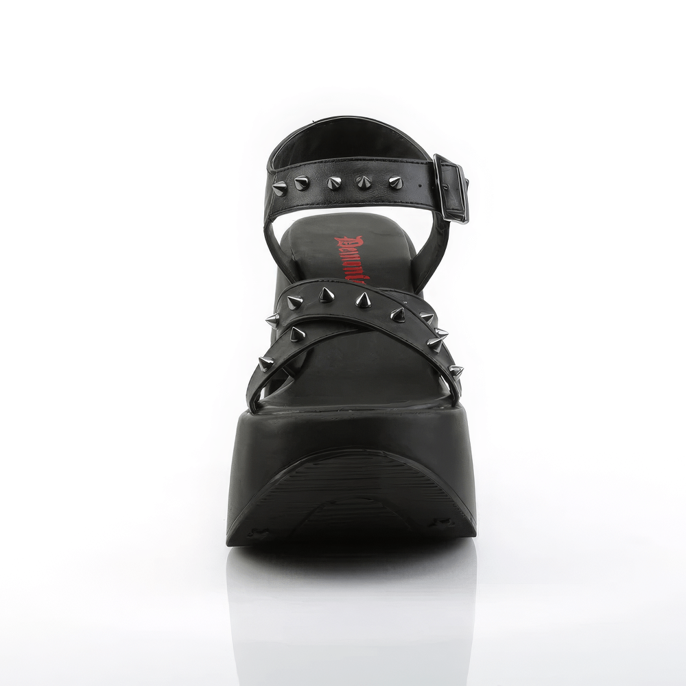 Demonia star cutout platform sandals with spike details, bold black vegan leather design and criss-cross ankle straps.
