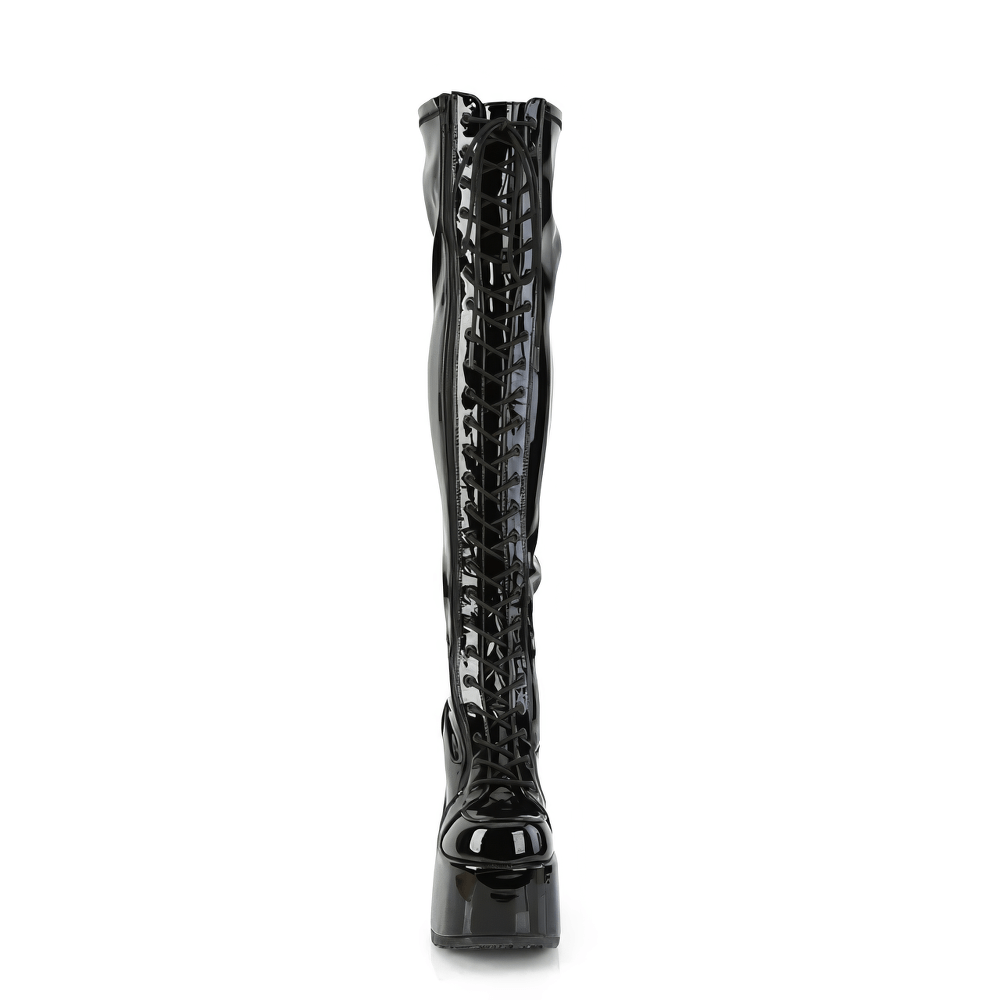 Black patent thigh-high boots with lace-up front and chunky platform heel, showcasing daring fashion style.