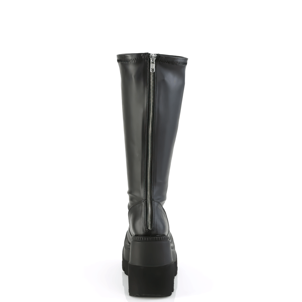 Back view of DEMONIA knee-high wedge boots with wide calf fit and metal zipper.