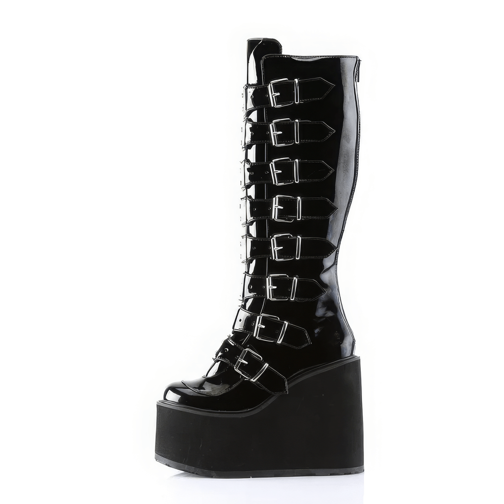 Daring black knee-high wedge platform boots with metal buckles and back zipper for bold fashion statements.