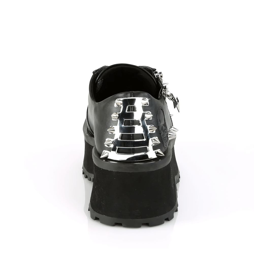 Back view of DEMONIA studded platform sneakers with chrome metal toe cap and ornamental zippers.