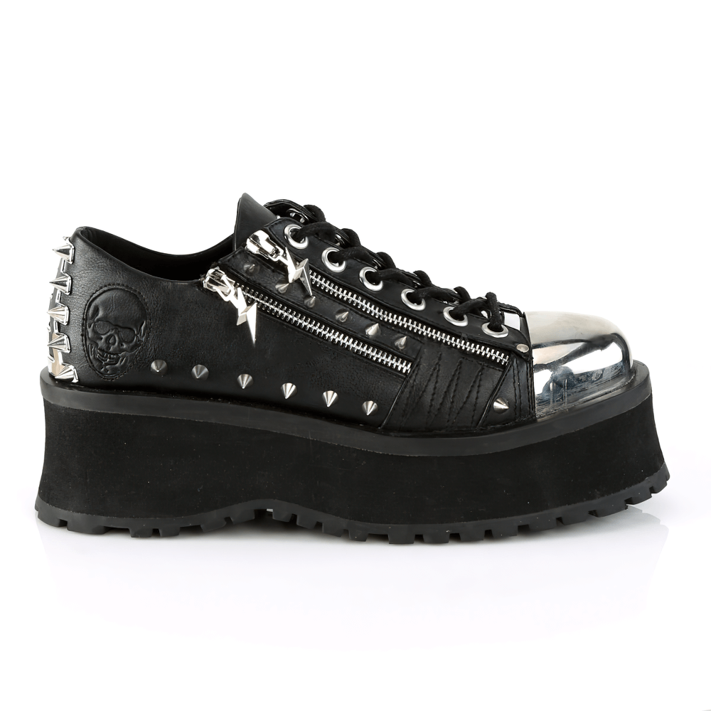 Daring DEMONIA studded platform sneakers with metal toe cap and ornamental zippers, featuring a bold punk design.