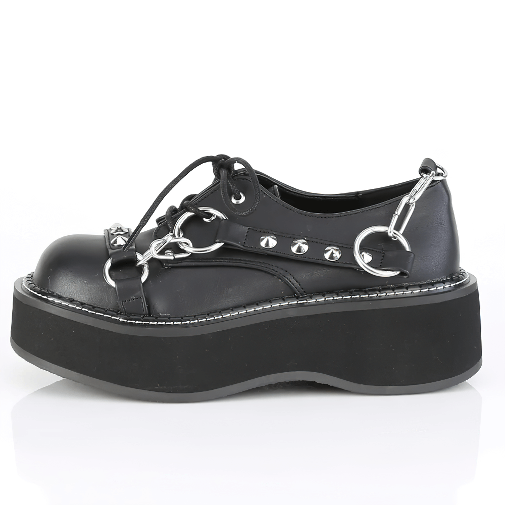Bold Demonia studded strap platform shoes with lace-up and metallic accents, perfect for a fashionable, edgy look.