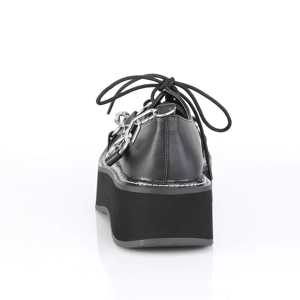 Back view of DEMONIA studded strap platform shoes with lace-up and metal chains for a bold look.