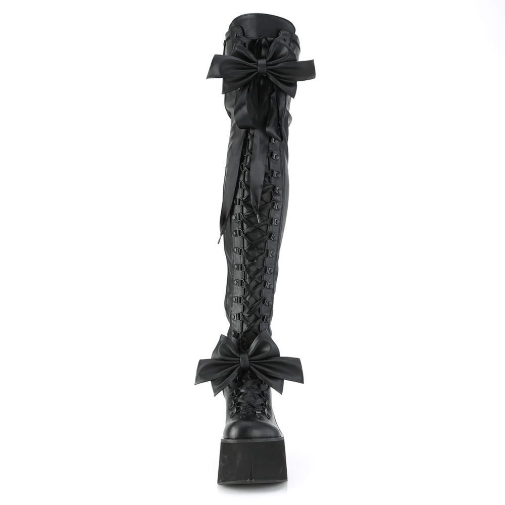 Daring Demonia thigh-high platform boots with removable bows and adjustable D-ring laces for a customizable fit.