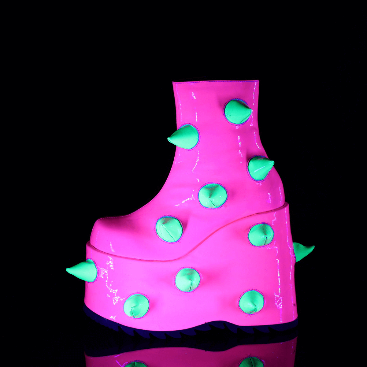 Daring UV neon pink wedge platform boots with playful green spikes, perfect for bold fashion statements.