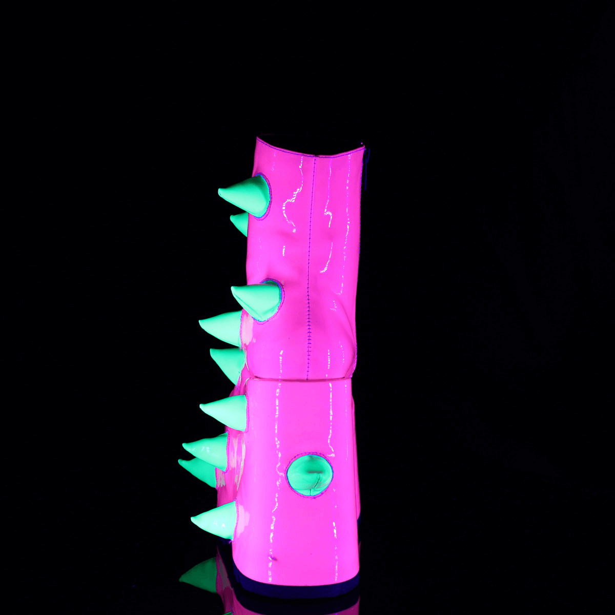 Daring UV neon pink wedge platform boots accented with playful green spikes, perfect for a bold fashion statement.