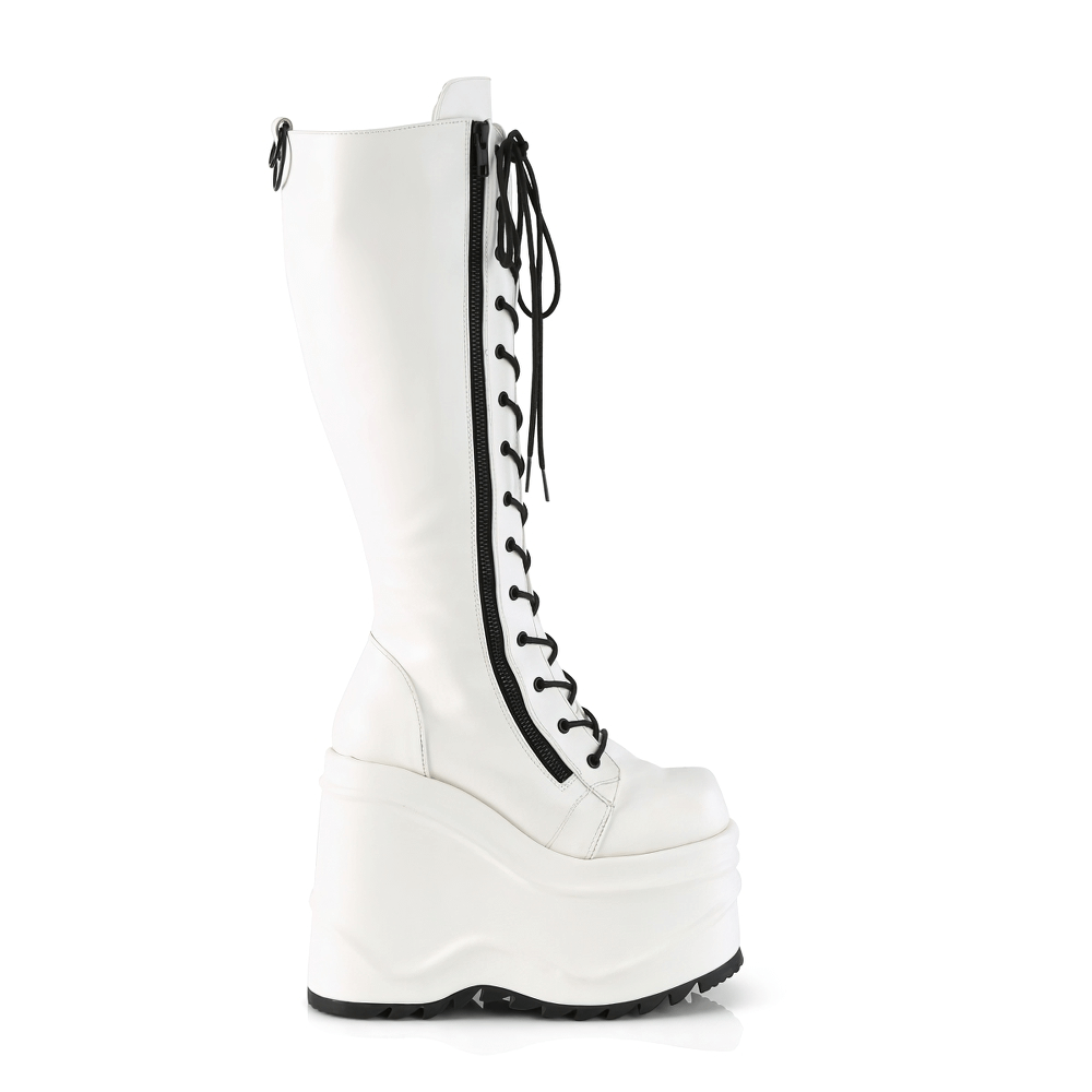 Daring Demonia white knee-high wedge platform boots with lace-up design and front zipper.