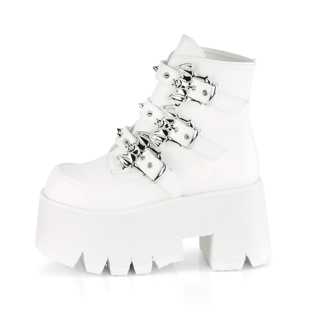 Demonia white ankle boots with studded bat buckles, 3.5-inch heel and cut-out platform for bold looks.