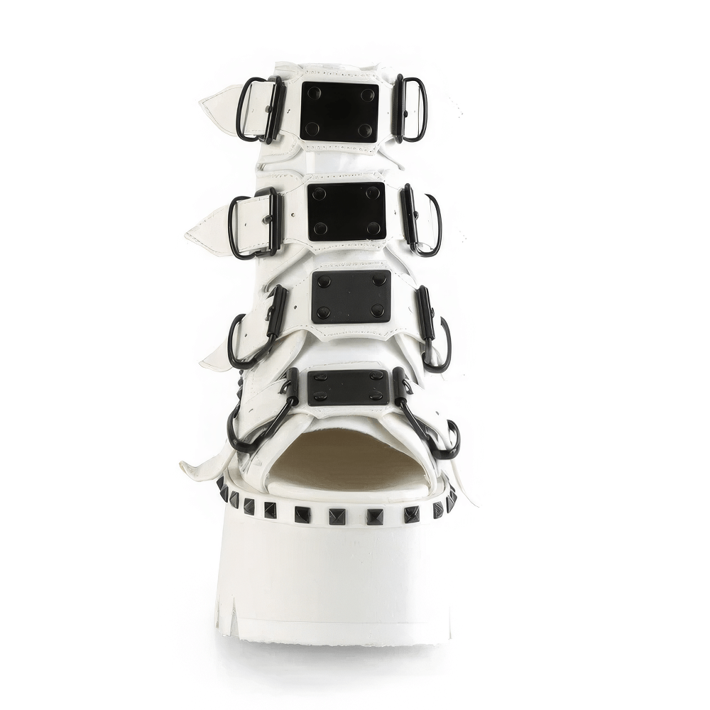 Demonia white chunky heel platform bootie sandals with matte black buckle straps and metal accents.